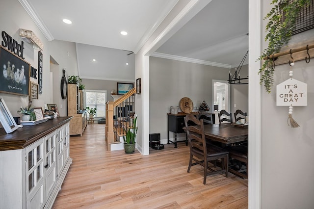 interior space featuring light wood-style floors, crown molding, stairway, and baseboards