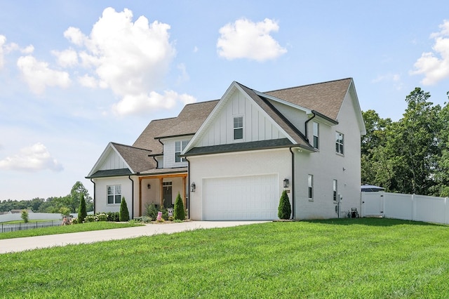 modern inspired farmhouse with roof with shingles, concrete driveway, board and batten siding, fence, and a front lawn