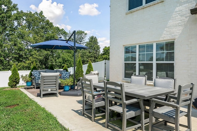 view of patio with outdoor dining area and fence