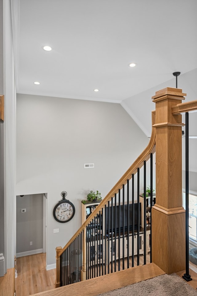 stairway with high vaulted ceiling, recessed lighting, wood finished floors, visible vents, and baseboards