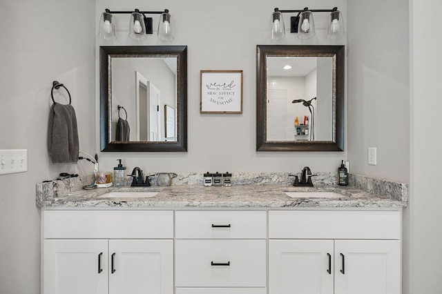 full bathroom featuring double vanity and a sink