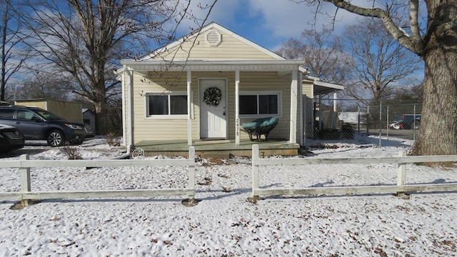 view of front of house with a fenced front yard and a porch