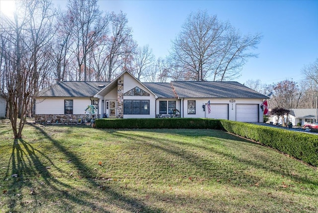 view of front facade with a garage, stone siding, a front lawn, and driveway