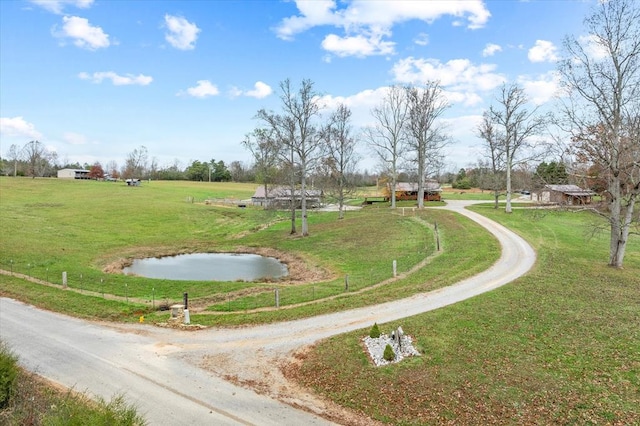 view of community with a rural view and a lawn