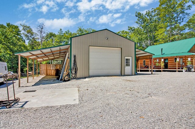 garage featuring driveway and a detached garage