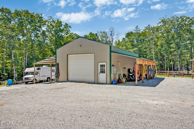 garage featuring driveway and a detached garage