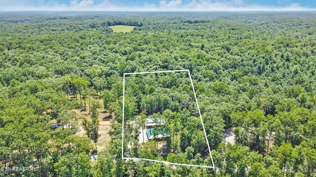 aerial view featuring a wooded view