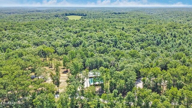 birds eye view of property featuring a wooded view