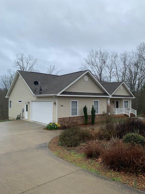 single story home featuring an attached garage and concrete driveway