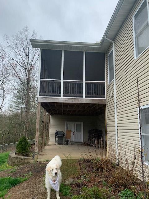 back of property with a sunroom and a patio