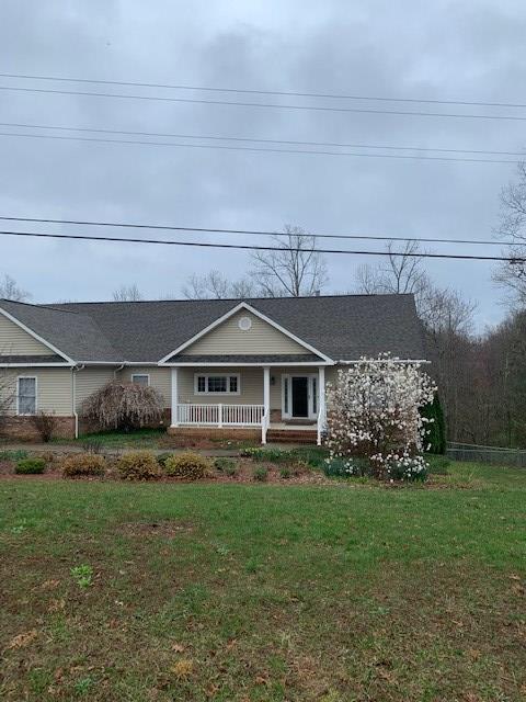 view of front facade featuring a front lawn and a porch