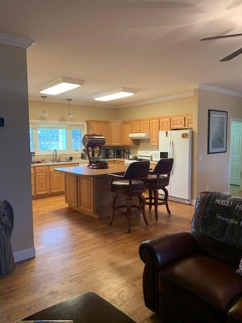 kitchen featuring light brown cabinets, a kitchen island, open floor plan, light countertops, and white fridge with ice dispenser