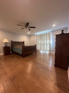 unfurnished bedroom featuring recessed lighting, crown molding, baseboards, and wood finished floors