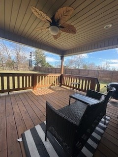 wooden deck with a fenced backyard and a ceiling fan