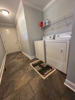 laundry area featuring ornamental molding, baseboards, and washing machine and clothes dryer