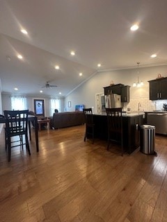 dining room featuring a ceiling fan, lofted ceiling, dark wood finished floors, and recessed lighting