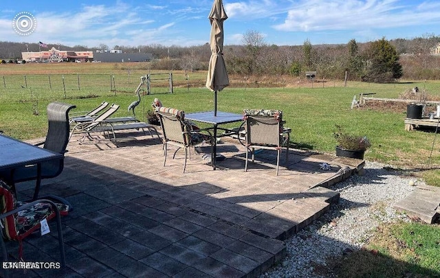 view of patio with fence and outdoor dining space