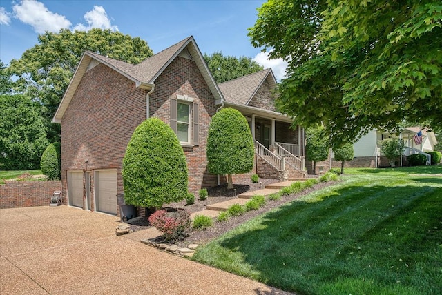 view of home's exterior featuring concrete driveway, a lawn, an attached garage, covered porch, and brick siding