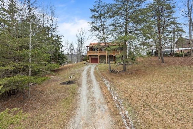 view of front facade with a garage, driveway, and a deck