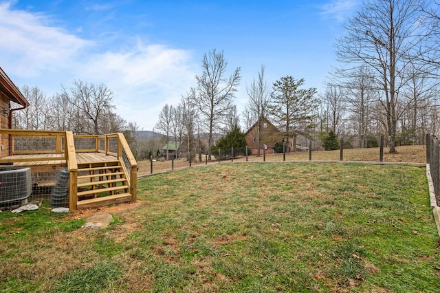 view of yard featuring central AC and fence