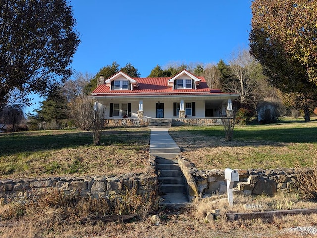 view of front of house featuring covered porch and a front lawn