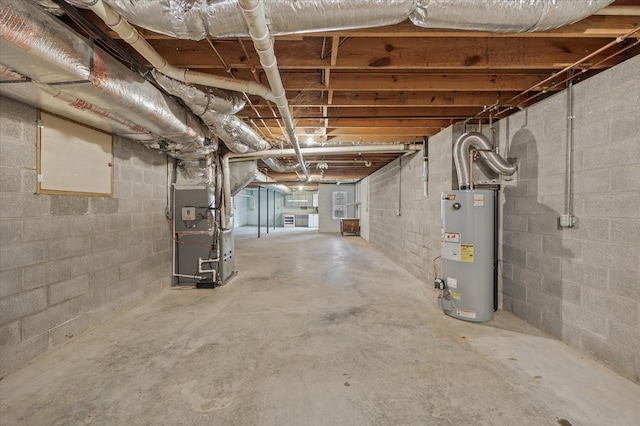 unfinished basement featuring heating unit and water heater