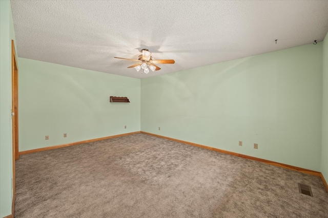 carpeted spare room with a textured ceiling, a ceiling fan, visible vents, and baseboards