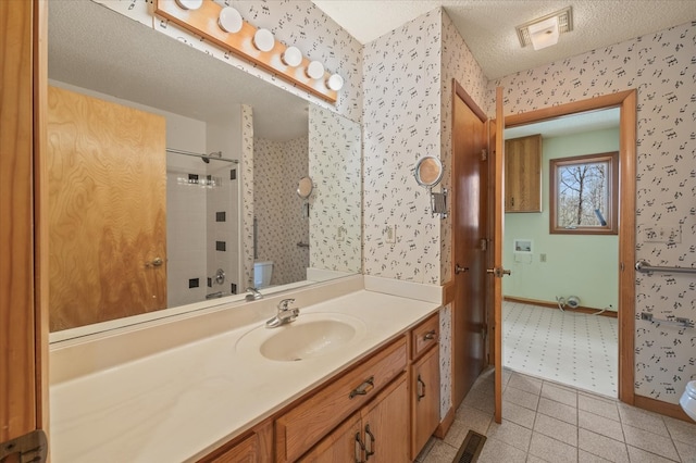 full bathroom featuring visible vents, a textured ceiling, a shower stall, and wallpapered walls