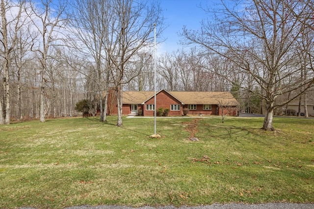 view of front of home with brick siding and a front lawn