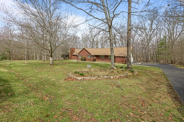 view of front of home with a front lawn and aphalt driveway