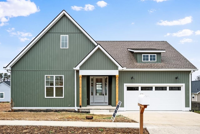 view of front facade featuring a garage, concrete driveway, and a shingled roof