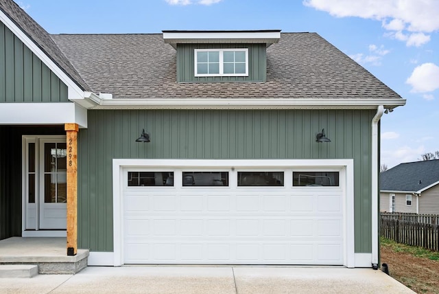 garage with driveway and fence