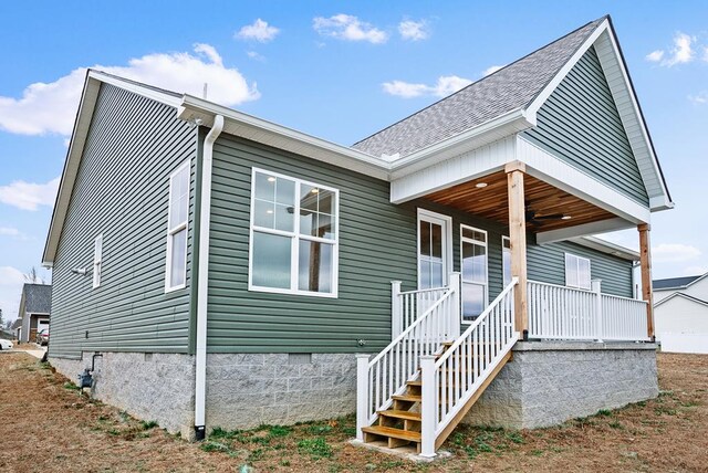 view of front of house with crawl space, a porch, and roof with shingles