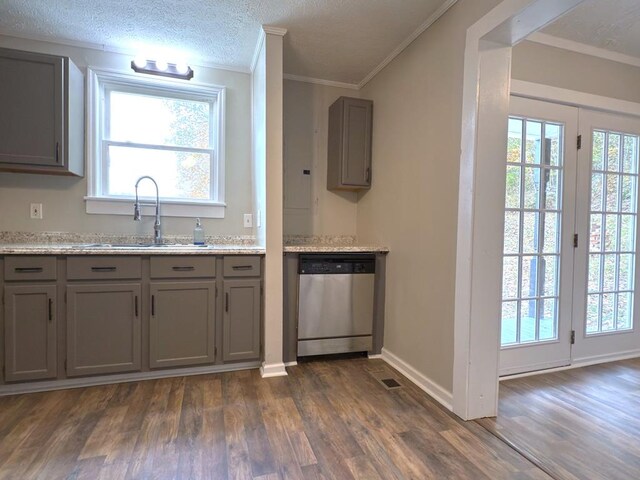 kitchen with dark wood-style floors, gray cabinetry, a sink, and stainless steel dishwasher