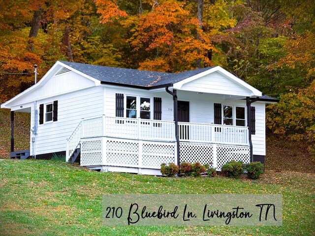 single story home featuring stairway, a front lawn, and a porch