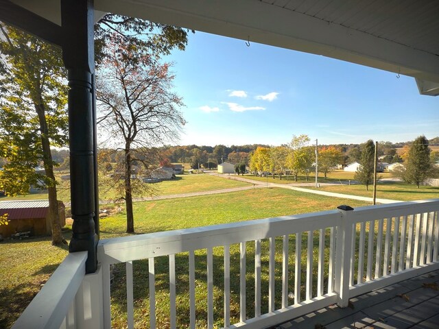 wooden deck featuring a lawn