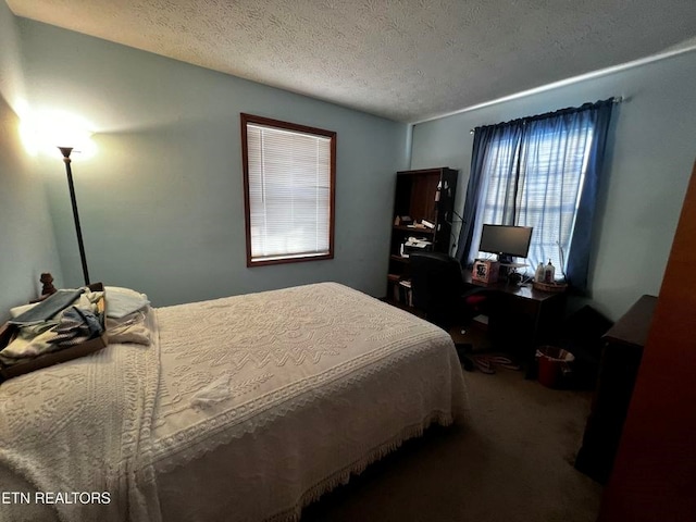 carpeted bedroom featuring a textured ceiling