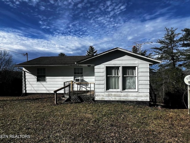 rear view of property with a yard