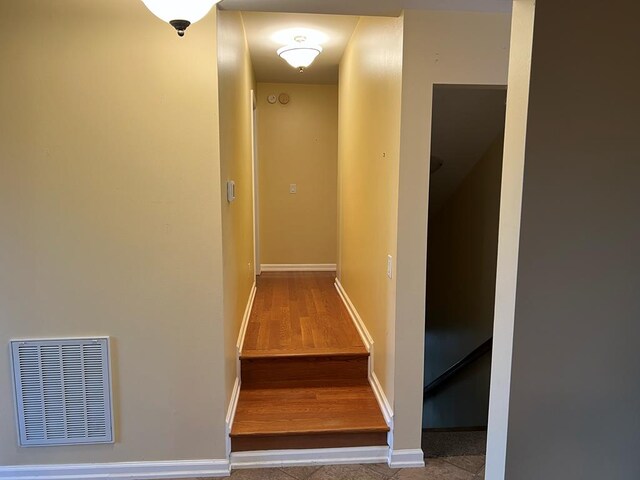 corridor featuring visible vents and baseboards