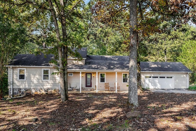 ranch-style house featuring covered porch and an attached garage