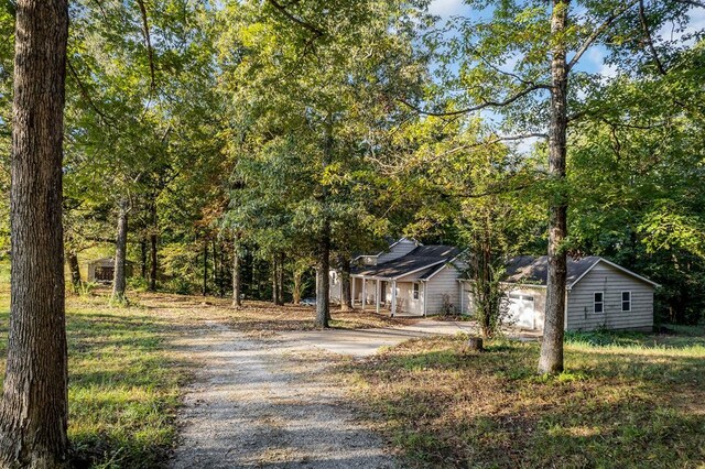 view of front facade with gravel driveway and an attached garage