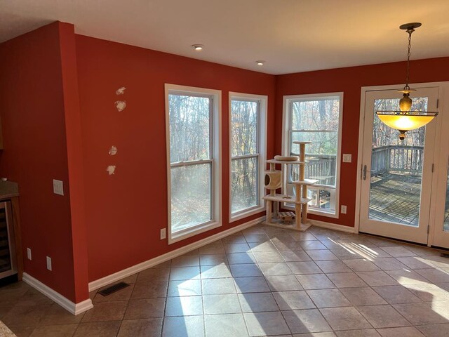 entryway with visible vents, baseboards, and tile patterned floors