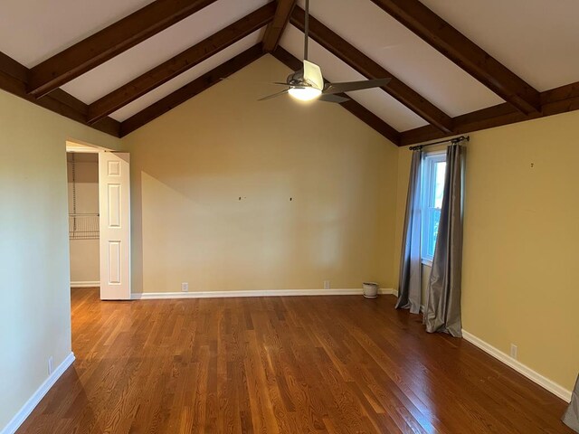 interior space featuring vaulted ceiling with beams, ceiling fan, baseboards, and dark wood-type flooring