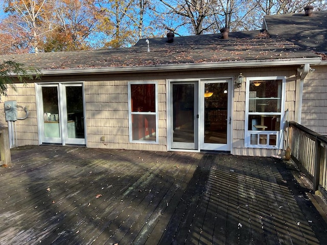 rear view of house featuring a wooden deck