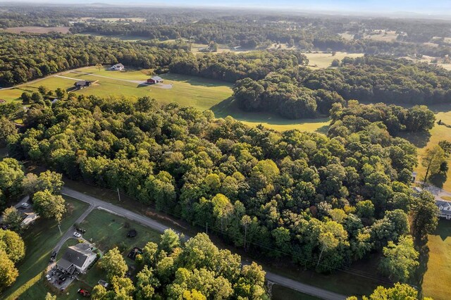 birds eye view of property featuring a view of trees