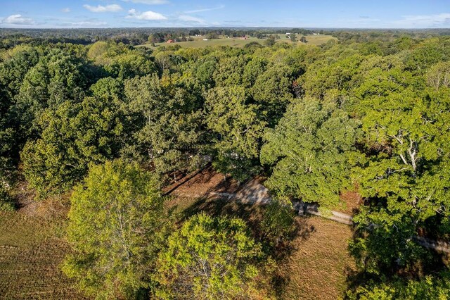 birds eye view of property with a view of trees