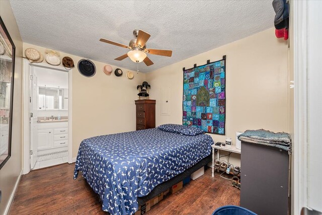 bedroom featuring a ceiling fan, dark wood-style flooring, a textured ceiling, and ensuite bathroom