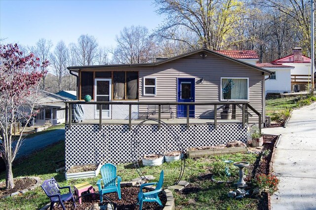 back of property with a sunroom