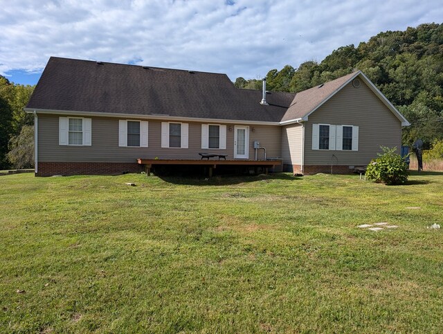 rear view of house with crawl space, a lawn, a shingled roof, and a wooden deck