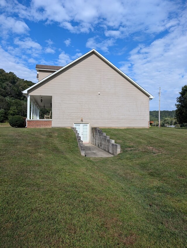 view of side of property with a yard